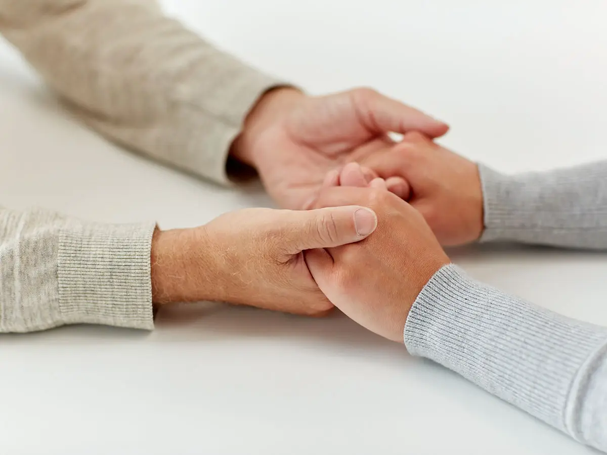Two people holding hands